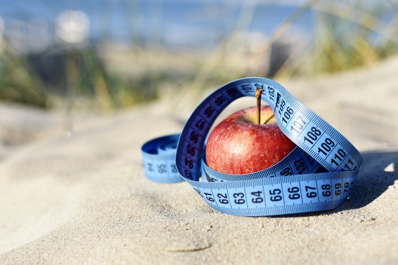 apple on a beach with tape measure