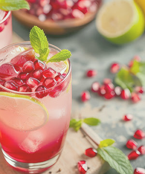 Energy drink including pomegranate and lime in a glass